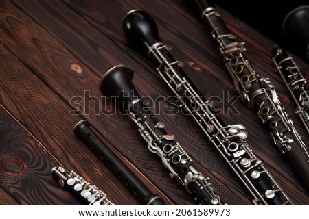 woodwind instruments on a wooden surface Royalty-Free Stock Photo #2061589973