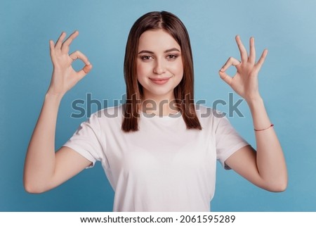 Photo of young cheerful girl show fingers okey alright symbol cool perfect ads isolated over teal color background