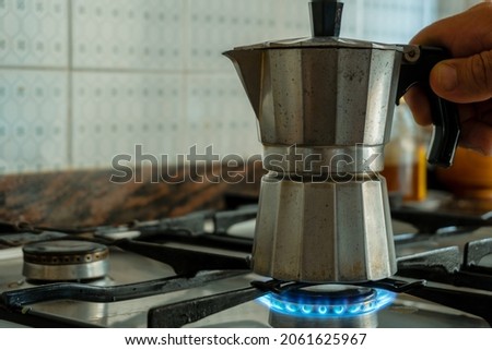 A little worn Italian coffee pot on a gas stove in a kitchen. Royalty-Free Stock Photo #2061625967