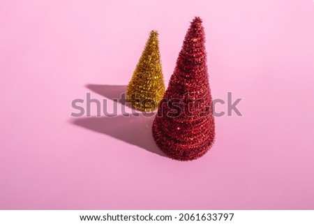 Colored Christmas trees on a pink background. Christmas concept
