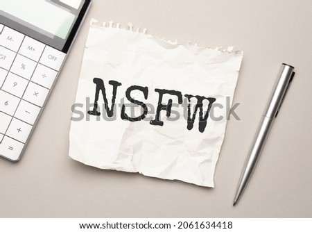 Hand with red pen. . Stick. calculator and white background. nsfw sign in the notepad Royalty-Free Stock Photo #2061634418