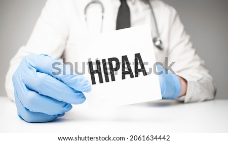 White sticker with text hipaa in doctor's hands with a stethoscope