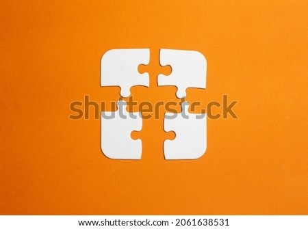 A incompatible equipment concept. pieces that do not fit together to work. copy space. white jigsaw pieces with orange background. Royalty-Free Stock Photo #2061638531