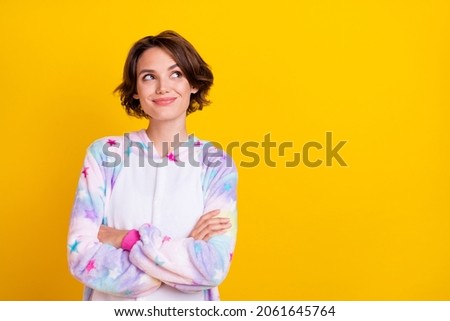 Photo portrait girl bob hairstyle smiling crossed hands in pajama looking copyspace isolated vivid yellow color background