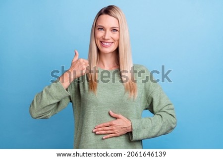 Photo of attractive mature woman arm on belly healthy show thumb-up great suggest advert isolated over blue color background Royalty-Free Stock Photo #2061646139