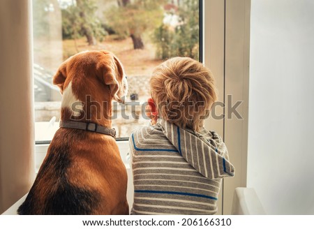 little boy with best friend looking through window Royalty-Free Stock Photo #206166310