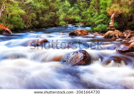 Watermeets point when two mountain river streams meet at the entrance to Lake St Clair, Tasmania.