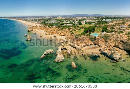 Aerial and panoramic view of Praia dos Tres Irmaos beach, Alvor, Algarve, Portugal