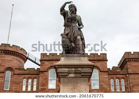 Statue of Flora MacDonald who helped Charles Edward Stuart evade government troops after the Battle of Culloden in 1746, with Inverness Castle in the background. Royalty-Free Stock Photo #2061670775
