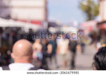 Blur and bokeh texture. People on the streets in the city on a summer day