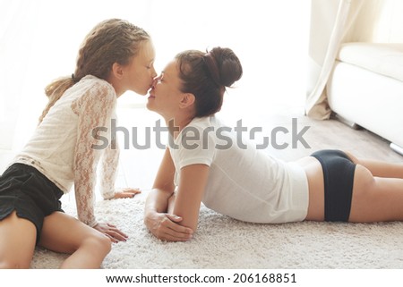 Mother with her preteen daughter at home