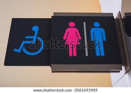 Toilet or WC symbol board. Colored toilet sign. Directions to the toilet or restroom or washroom. Toilet for disabled 