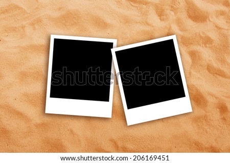Top View of Two Blank photo frames on beach sand texture. Copy space for your images.