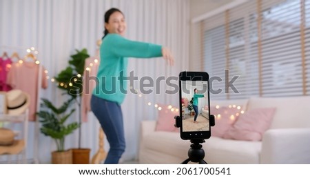 Asia vlogger woman influencer smile enjoy hobby happy fun live online screen SME retail store in IG reel tiktok at home. Gen Z talent people play video selfie shoot app for show share viral story. Royalty-Free Stock Photo #2061700541