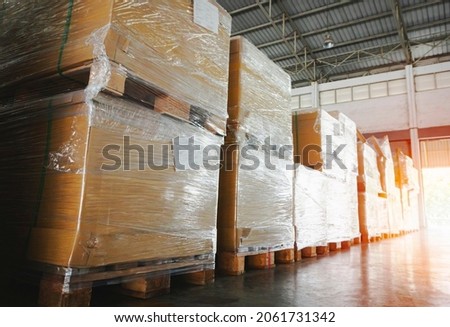 Package Boxes Wraaped Plastic Film on Pallets in Storage Warehouse. Supply Chain. Storehouse Cargo Shipment. Shipping Warehouse Logistics.	