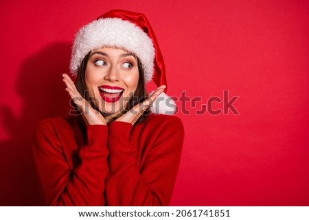 Photo of sweet impressed lady dressed pullover arms cheeks looking empty space celebrating new year isolated red color background