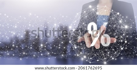 Interest rate, financial, ranking and mortgage rates concept. Hand touch digital screen hologram percent sign on city light blurred background