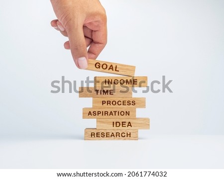7 options or steps infographic for business concept. Hand put the last wood block on the top of the stack of wooden blocks with words of the key to success and icons on white background.