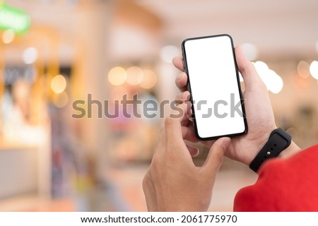 Man holding smart phone with blurred background. For Graphic display montage,copy space warm colours sun light
