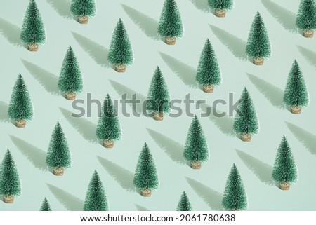 Arranged green New Year and Christmas tree mint pastel background. Pattern.