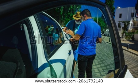 Сar salesman and lender making deal. View from car window. Before lender signing deal leasing, signing a contract with cautious.
