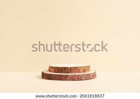 Round wooden podium on beige background for product.