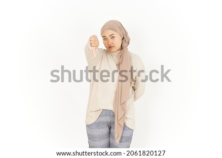 Thumbs Down of Beautiful Asian Woman Wearing Hijab Isolated On White Background