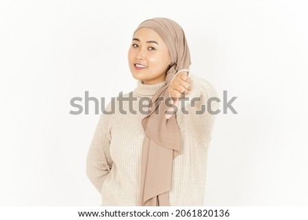 Thumbs Down of Beautiful Asian Woman Wearing Hijab Isolated On White Background