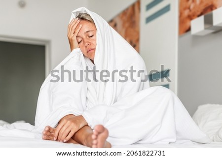 Sleepless middle-aged woman lying in bed suffers from insomnia sleep disorder cant sleep till morning, depressed middle aged sad female with close eyes at bedroom Royalty-Free Stock Photo #2061822731