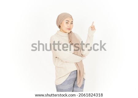 Presenting and Pointing Up of Beautiful Asian Woman Wearing Hijab Isolated On White Background