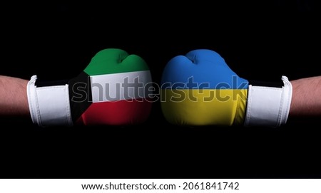 Two hands of wearing boxing gloves with Ukraine and Kuwait flag. Boxing competition concept. Confrontation between two countries