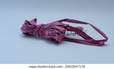 cheap and flammable plastic red rope on isolated background