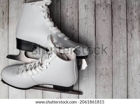Figure skates on a wooden background. Flat lay, top view. High quality photo