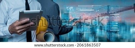 Double exposure engineering team using tablet computer and digital technology interfaces icon on construction cranes background, Technology and business industrial concept. Royalty-Free Stock Photo #2061863507