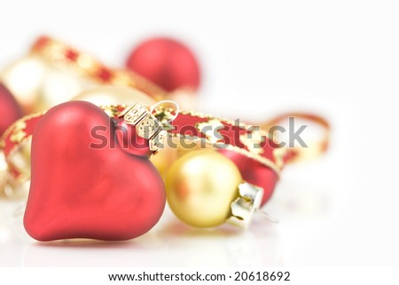 Red and gold christmas ornaments on white background