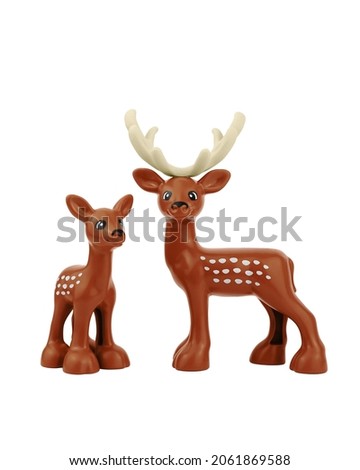 Two plastic deer toys isolated on white background.