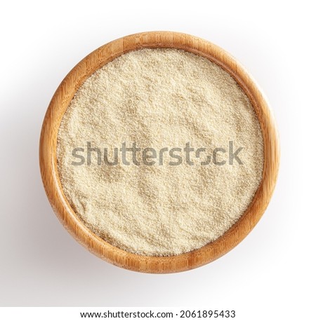 Semolina flour in wooden bowl isolated on white background Royalty-Free Stock Photo #2061895433