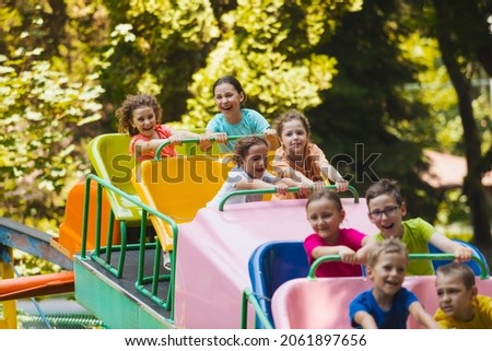 The children experience great emotions of roller coaster riding Royalty-Free Stock Photo #2061897656