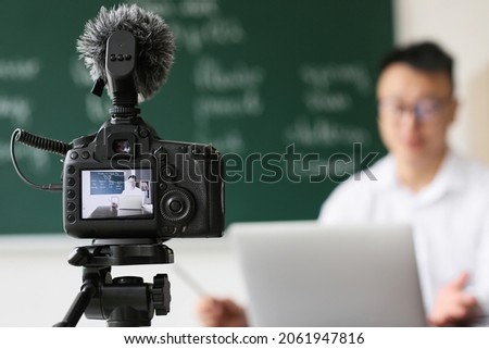 Asian teacher conducting English lesson online