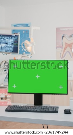 Nobody in dental cabinet with green screen on computer for teethcare. Empty dentist office with isolated background and mockup template on monitor for chroma key. Oral care and dentition