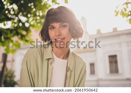 Photo of sweet adorable young woman wear green shirt rucksack smiling walking outside city street