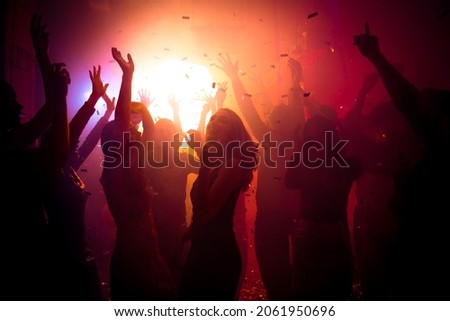 Photo of carefree lady friendship have corporate festival buddies on neon modern disco with flying confetti hands up