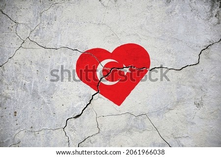 The symbol of the national flag of Turkey in the form of a heart on a cracked concrete wall. Concept.