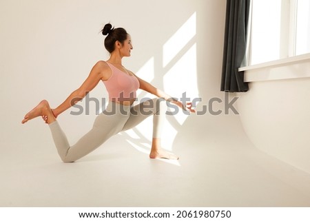 young flexible girl does yoga and gymnastics, flexibility and stretching