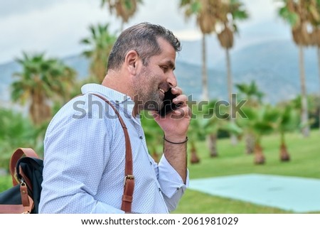 Mature business man talking on the phone outdoors
