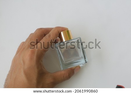 glass perfume bottle with gold cap on white isolated background