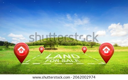 Land plot management - real estate concept with a vacant land on a green field available for building construction and housing subdivision in a residential area for sale, rent, buy or investment. Royalty-Free Stock Photo #2062002974