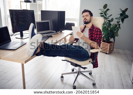 Full length photo of serious minded young man sit table write note imagine coder editor indoors inside office