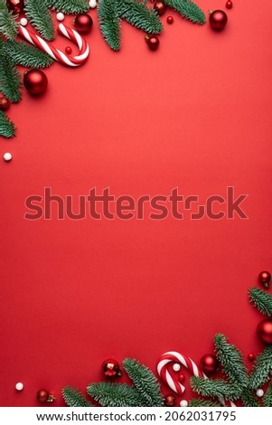 Red Christmas background with fir branches and decorations. Holiday design with place for text
