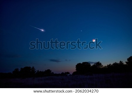 Landscape silhouette of a evening sky with crescent Moon eclipse, meteor, shooting star and planets.